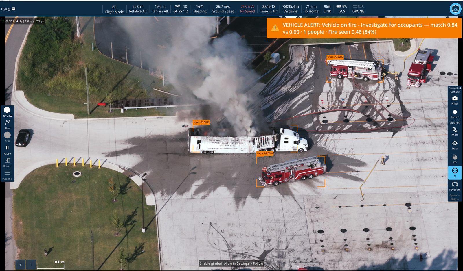 An overhead view of a car park where an articulated tanker is alight, black smoke streaming across the tarmac. Two fire engines already on scene are boxed and labelled at 62 and 66 percent, the burning trailer at 56 percent. An amber banner reads 'VEHICLE ALERT: Vehicle on fire - Investigate for occupants — match 0.84 vs 0.00 · 1 people · Fire seen 0.48 (84%)'.