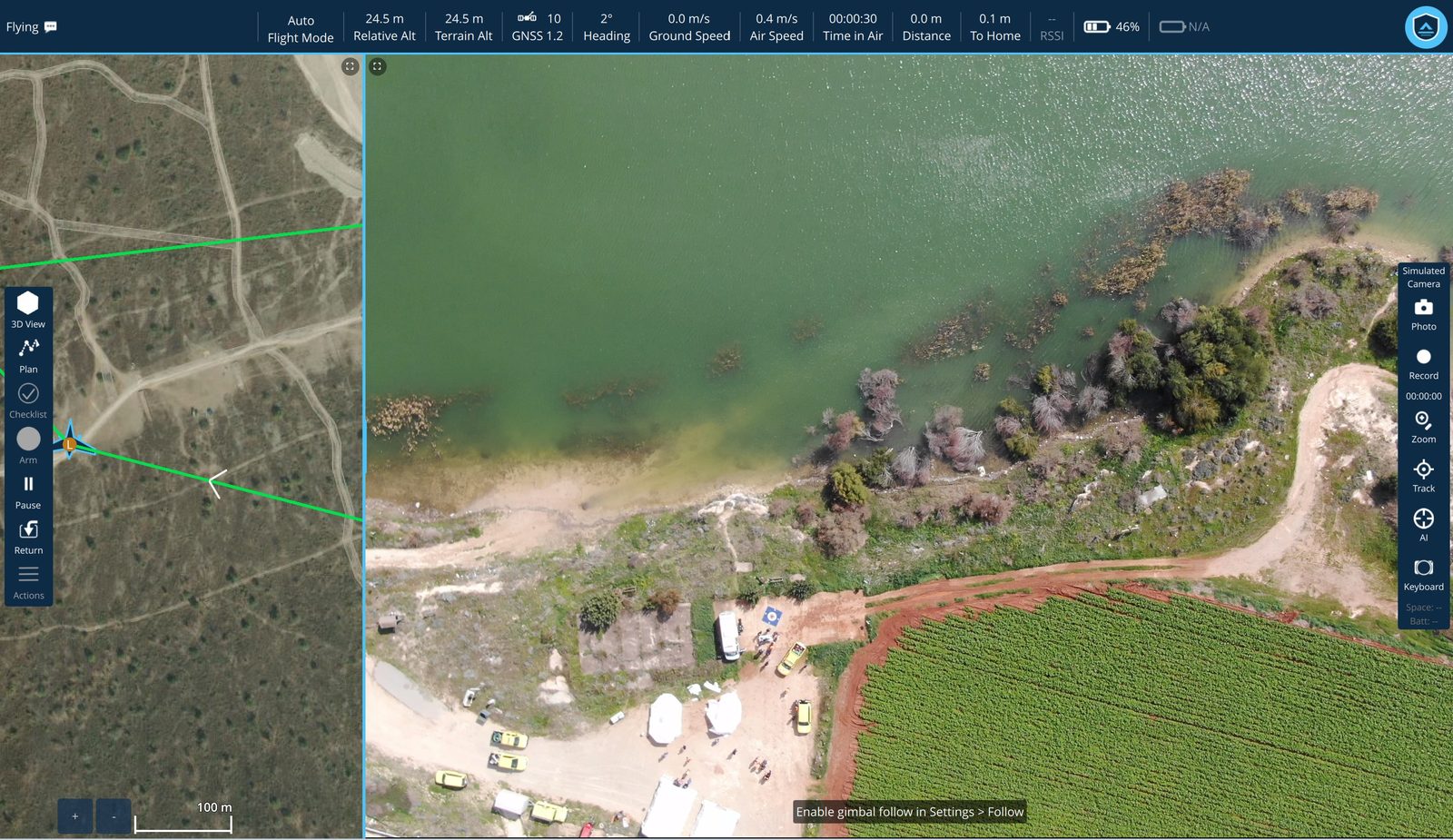 Fly View: satellite map with the flight path on the left, live aerial video of a shoreline and field on the right showing vehicles and people on the ground, telemetry across the top.