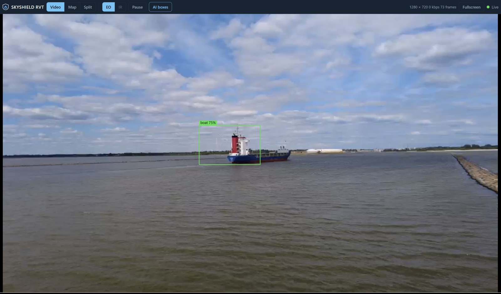 The Remote Video Terminal open in a plain browser: a control bar with Video, Map and Split views, EO and IR camera sources, Pause and an AI boxes toggle, a green Live indicator and the stream size, over sharp aerial video of a cargo ship on a wide estuary with a green detection box labelled boat 75 percent drawn around it.