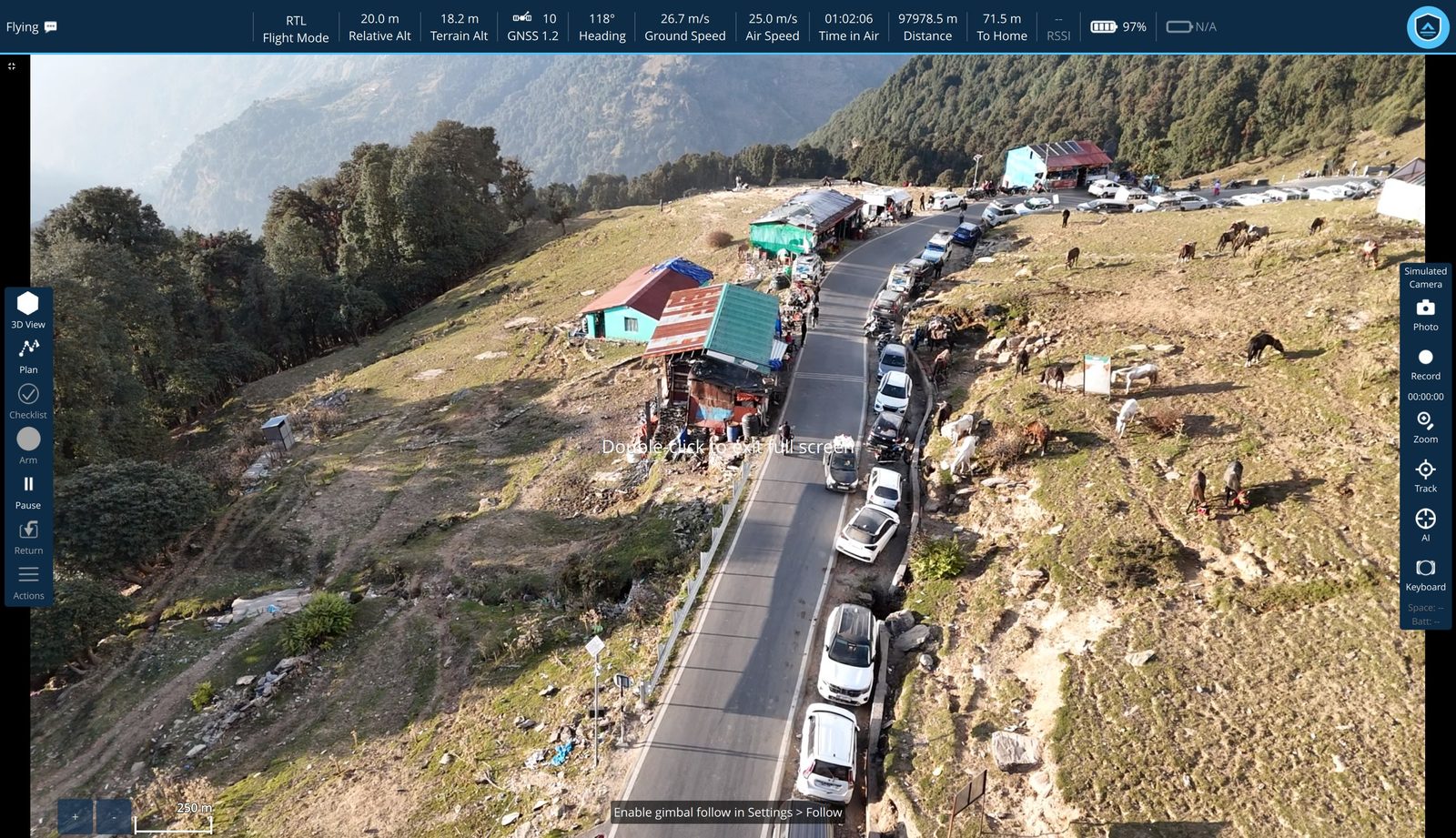 The station in full-screen video over a mountain road, cars and pack animals visible along the route, with only the telemetry bar and camera toolbar over the picture — no floating panels, no analytics overlay.